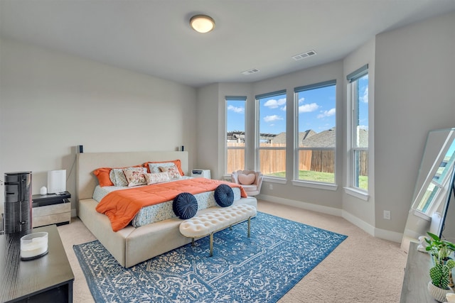 bedroom with light carpet, baseboards, and visible vents