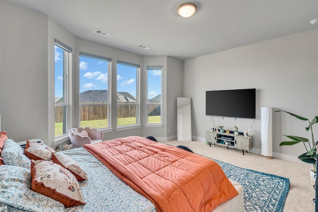 carpeted bedroom with visible vents and baseboards