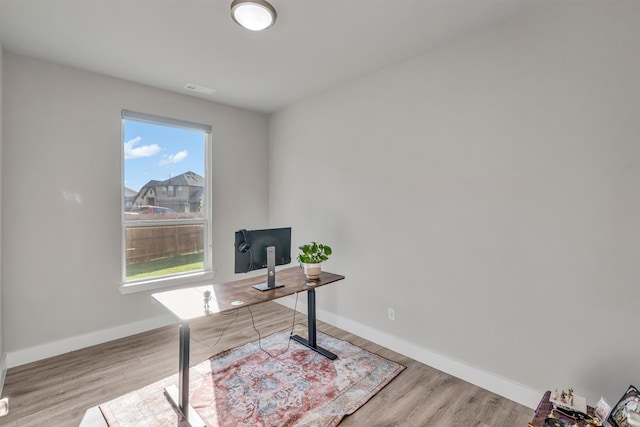 home office with light wood finished floors and baseboards