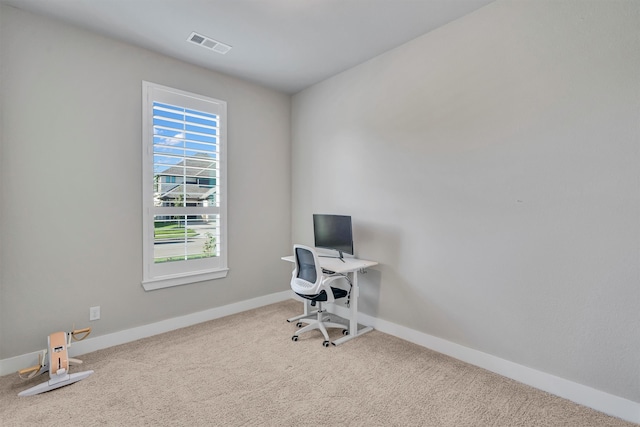 office space with carpet floors, baseboards, and visible vents