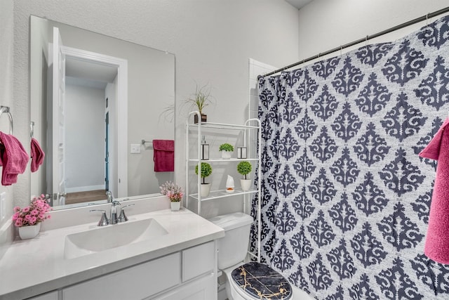 2104 Devonblue Dr, Forney, TX 75126 - full bathroom with toilet, vanity, a shower with shower curtain, and a textured wall
