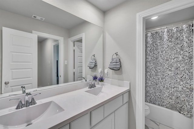 full bath with toilet, a sink, visible vents, marble finish floor, and double vanity