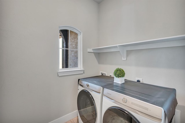 laundry area featuring laundry area, independent washer and dryer, and baseboards