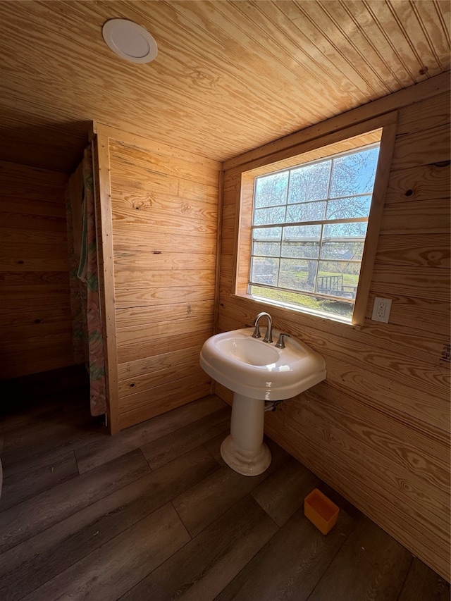 bathroom with wood-type flooring, wooden ceiling, and wooden walls