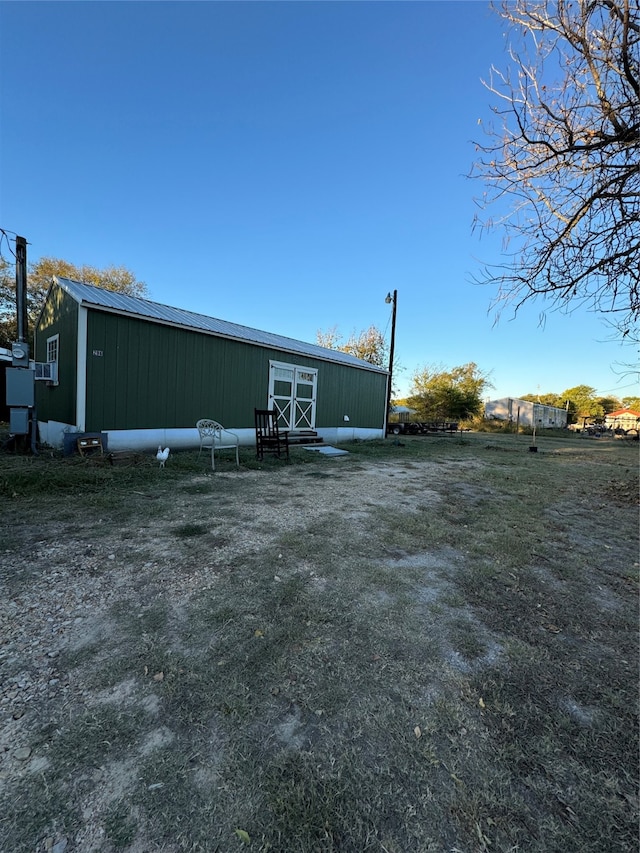 back of house featuring an outbuilding