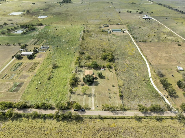 birds eye view of property with a rural view