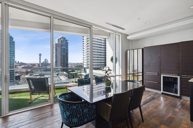 dining room featuring expansive windows, dark wood-type flooring, and a wealth of natural light