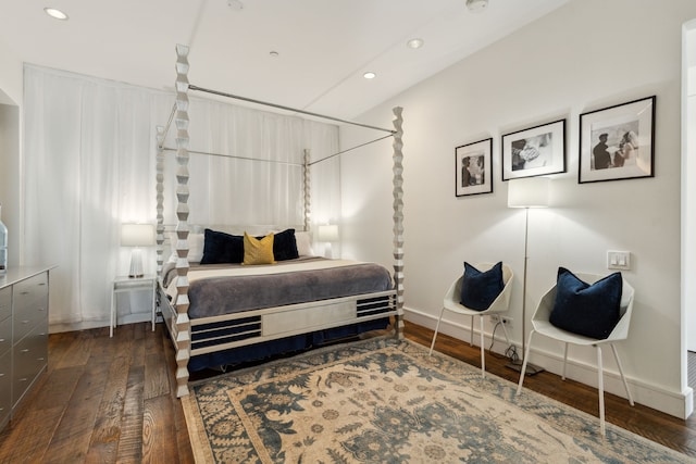 bedroom with dark hardwood / wood-style floors