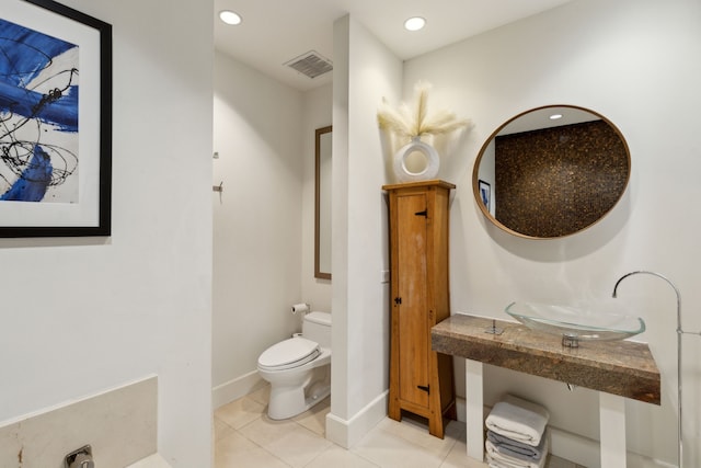 bathroom with tile patterned floors, toilet, and sink