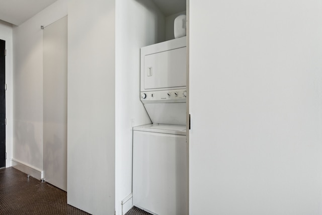 clothes washing area featuring stacked washer and dryer