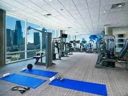 gym with expansive windows and carpet floors