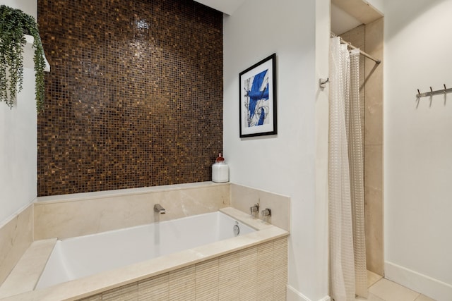 bathroom featuring tiled tub and tile patterned floors