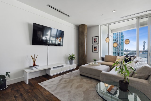 living room with dark wood-type flooring and a wall of windows