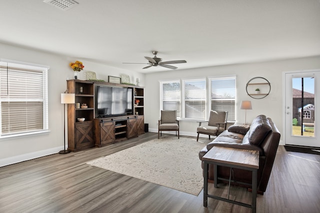 living room featuring ceiling fan and hardwood / wood-style floors