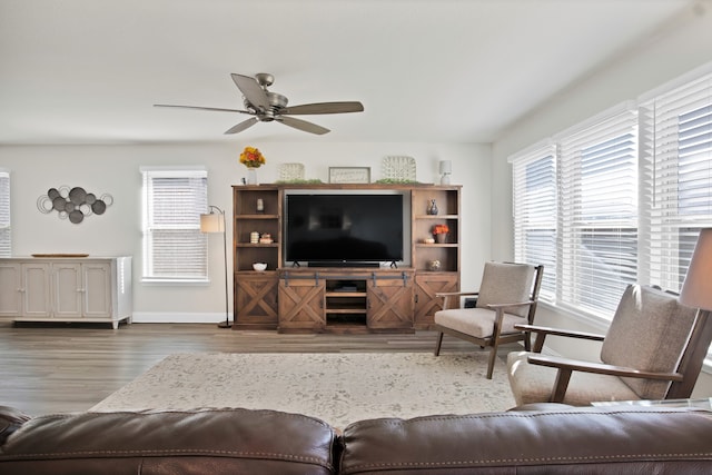 living room featuring ceiling fan and dark wood-type flooring