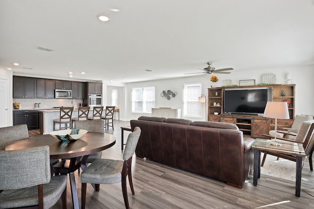 dining space featuring light hardwood / wood-style floors and ceiling fan