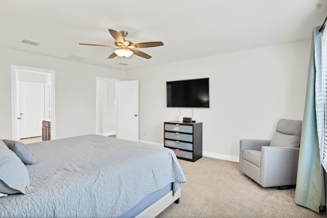 bedroom with ensuite bath, ceiling fan, and light colored carpet