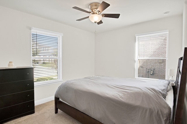 bedroom with ceiling fan and light colored carpet