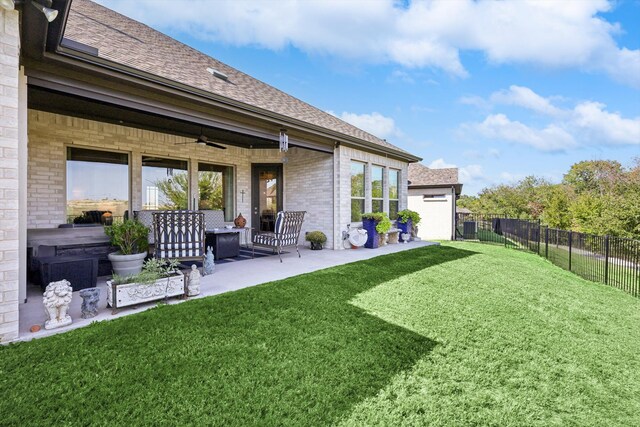 back of house featuring a yard, a patio area, and ceiling fan