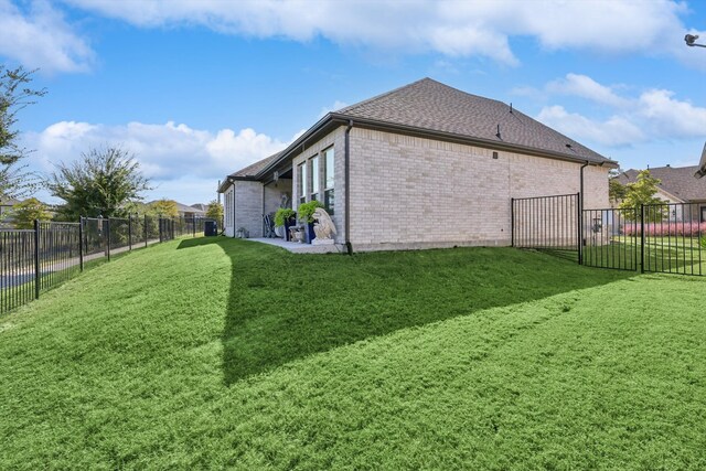 view of side of property with a lawn