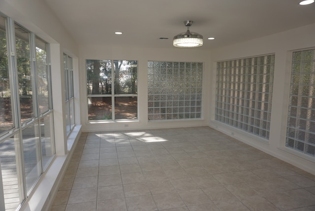 unfurnished sunroom featuring a wealth of natural light