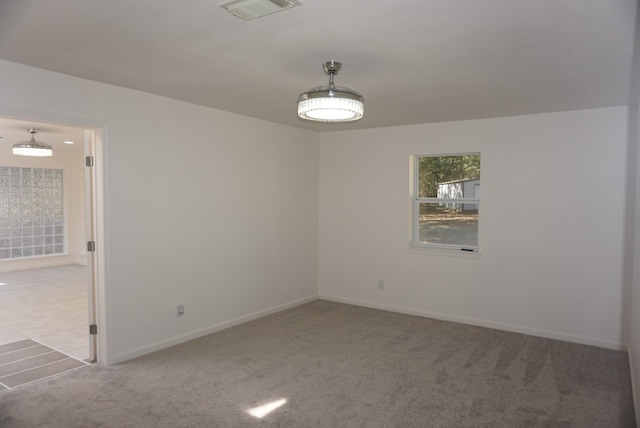 unfurnished room with light colored carpet