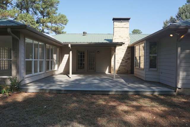 rear view of property with a wooden deck