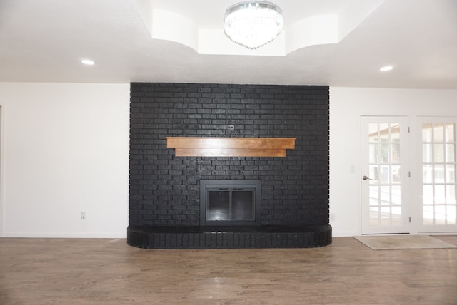 unfurnished living room featuring a fireplace and wood-type flooring