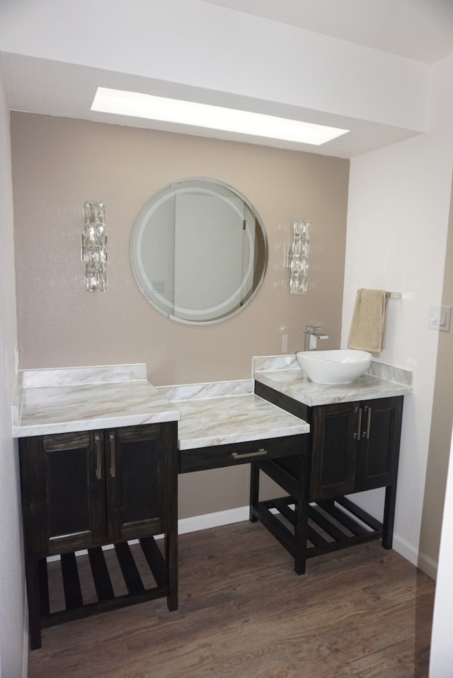 bathroom with hardwood / wood-style flooring and vanity