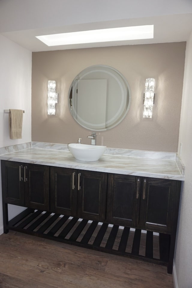 bathroom with hardwood / wood-style flooring and vanity