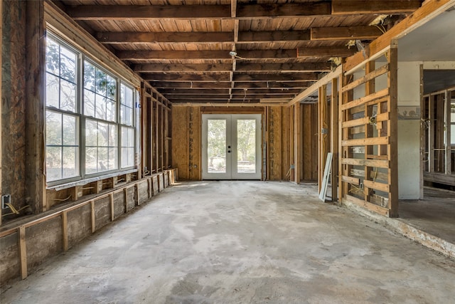 miscellaneous room featuring french doors and concrete flooring