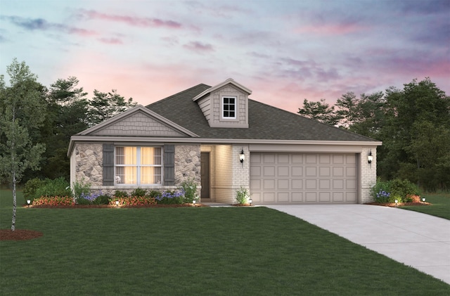 view of front of home featuring a garage and a lawn