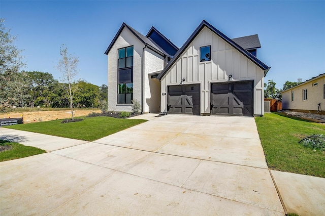 modern inspired farmhouse featuring a garage and a front lawn