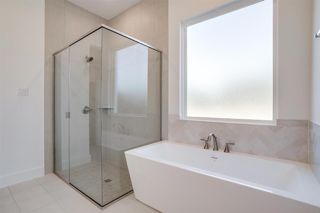 bathroom with separate shower and tub, tile walls, and tile patterned floors