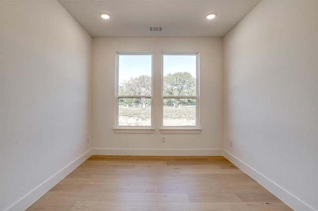 spare room with light hardwood / wood-style flooring