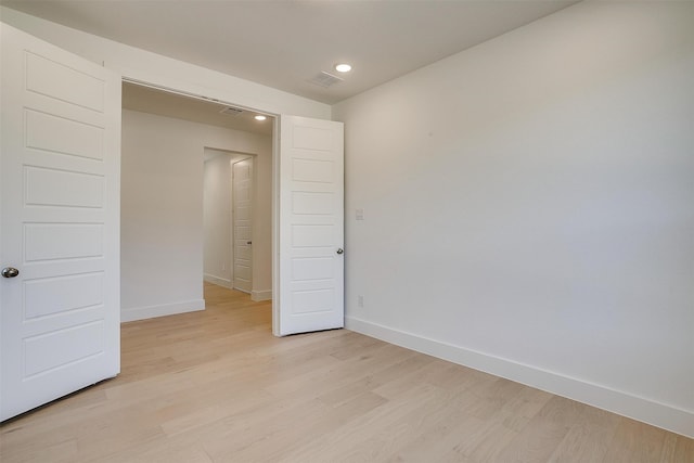 spare room with light hardwood / wood-style floors