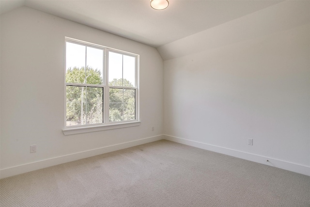 additional living space with lofted ceiling, a healthy amount of sunlight, and carpet floors