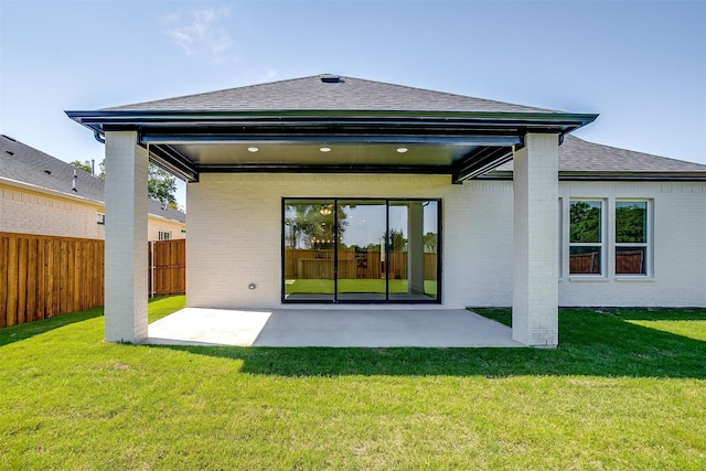 back of property with a patio and a lawn