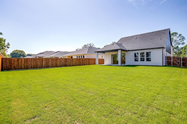 rear view of property with a patio area and a lawn