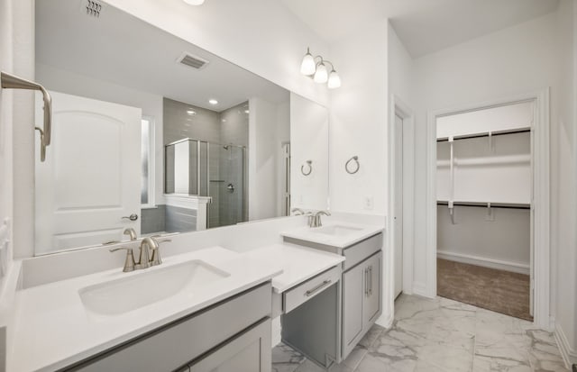 bathroom with walk in shower and vanity