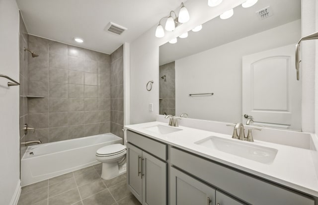 full bathroom featuring tile patterned flooring, vanity, toilet, and tiled shower / bath