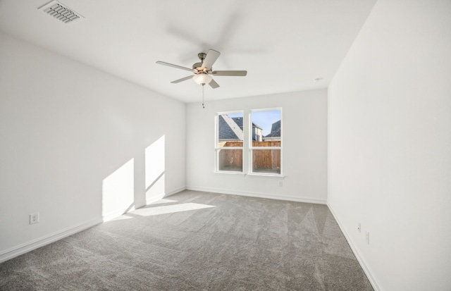 carpeted empty room featuring ceiling fan