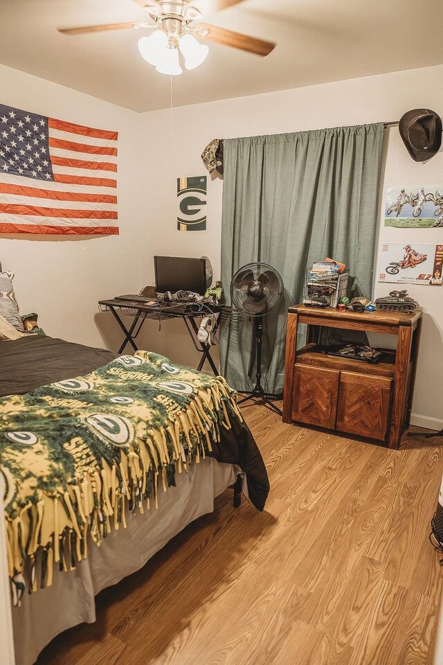 home office with hardwood / wood-style flooring, a wall mounted air conditioner, and ceiling fan