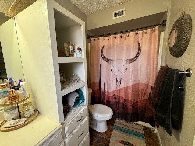 bathroom with vanity and a textured ceiling