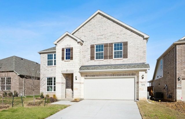 view of property with a garage, central air condition unit, and a front lawn