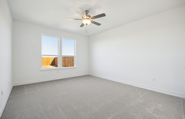 empty room with carpet flooring and ceiling fan