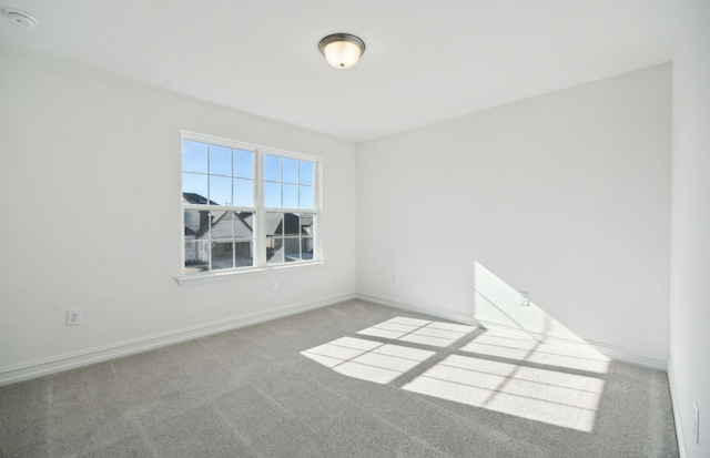 unfurnished room featuring light colored carpet