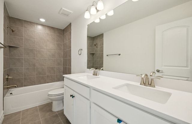 full bathroom featuring vanity, tile patterned floors, toilet, and tiled shower / bath