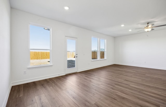 spare room with dark wood-type flooring and ceiling fan