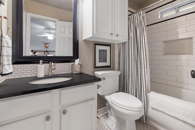 full bathroom with ceiling fan, shower / tub combo, vanity, tile patterned floors, and toilet